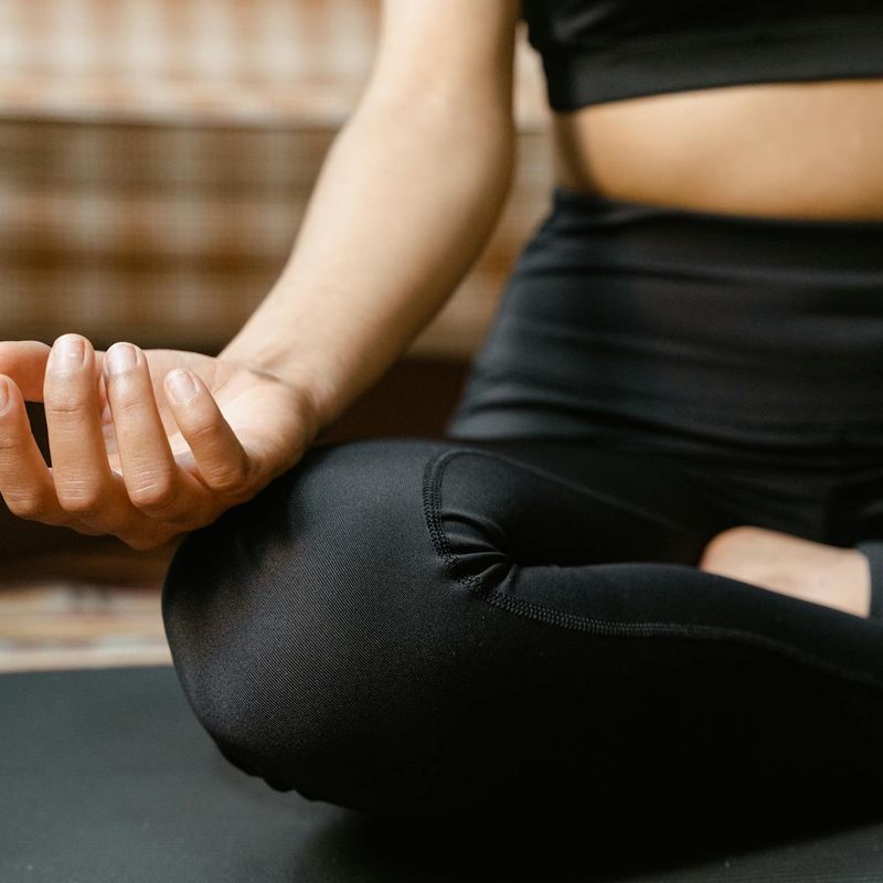 Close-up of a person's hands in a meditative yoga pose.